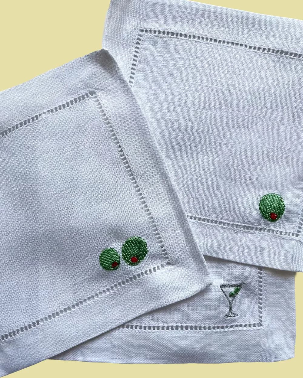 Close-up of an embroidered cherry motif on a napkin